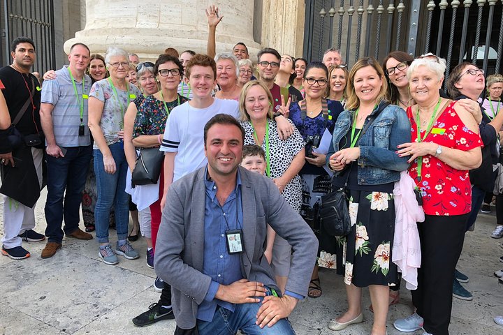 A guide and tour group standing outside