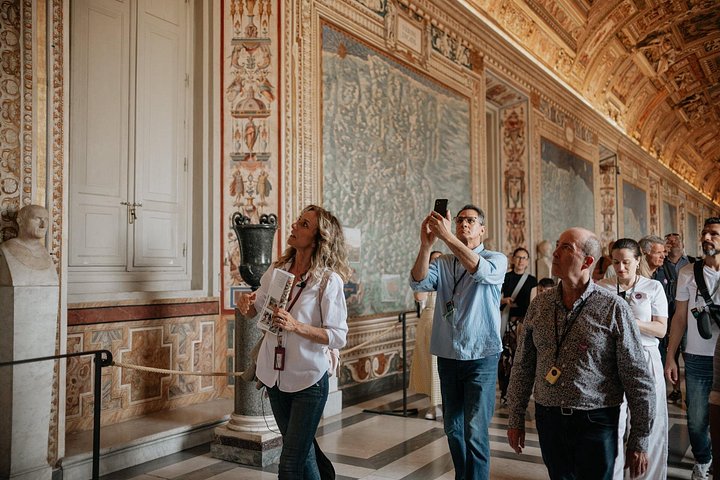 A guide with visitors in the Vatican Gallery of Maps