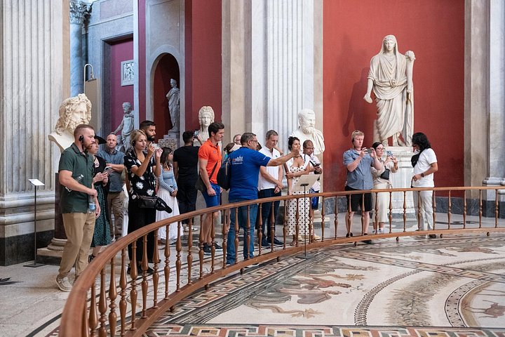 A group visiting a sculpture hall in the Vatican Museums