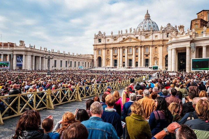 Visitors seated in rows in St. Peter’s Square