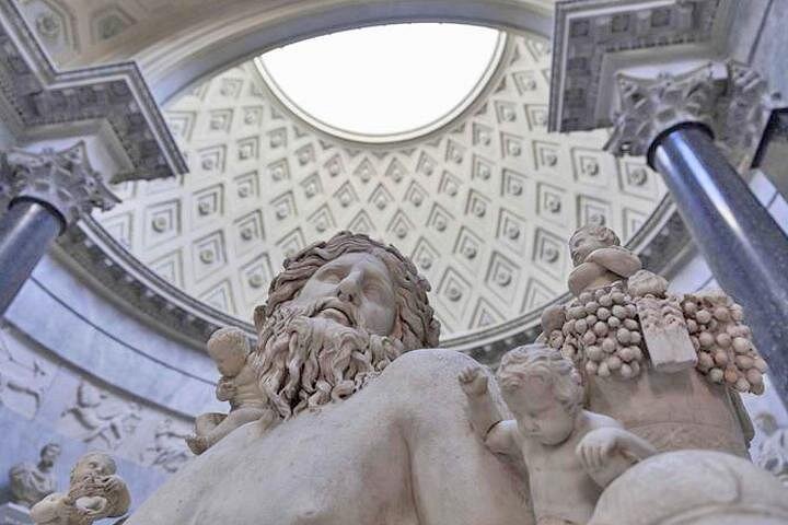 A marble sculpture beneath a Vatican museum rotunda