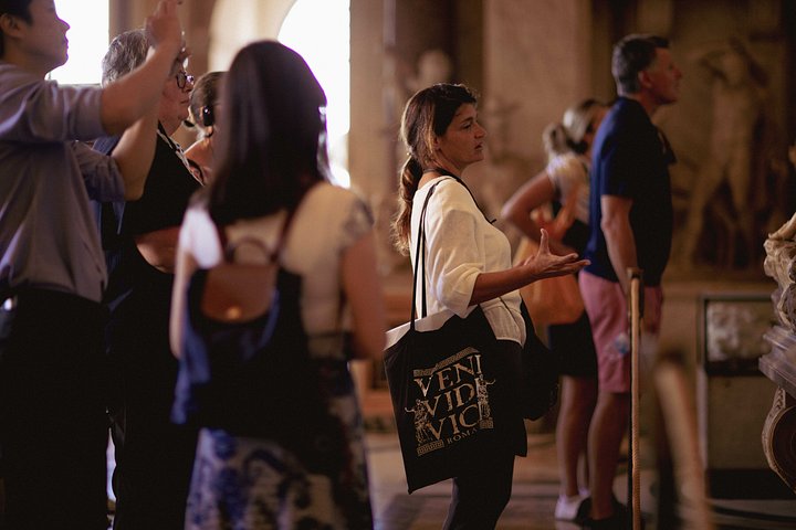 A guide speaking to visitors in the Vatican Museums